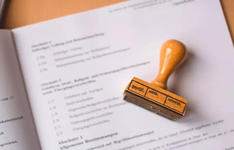 Ein Holzstempel liegt auf einem Blatt Papier