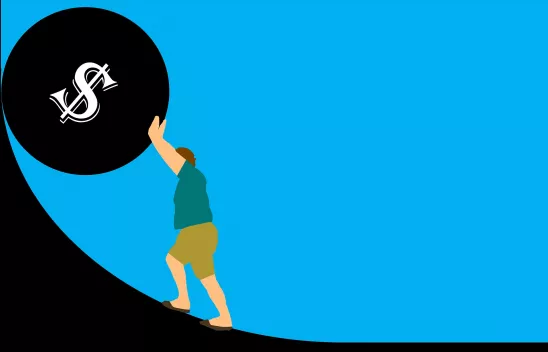 Eine Grafik von einem Mann, der vor blauem Hintergrund eine schwarze große Kugel, auf der ein $-Zeichen abgebildet ist, eine schwarze Steigung hinaufschiebt. Eine Grafik von einem Mann, der vor blauem Hintergrund eine schwarze große Kugel, auf der ein $-Zeichen abgebildet ist, eine schwarze Steigung hinaufschiebt.