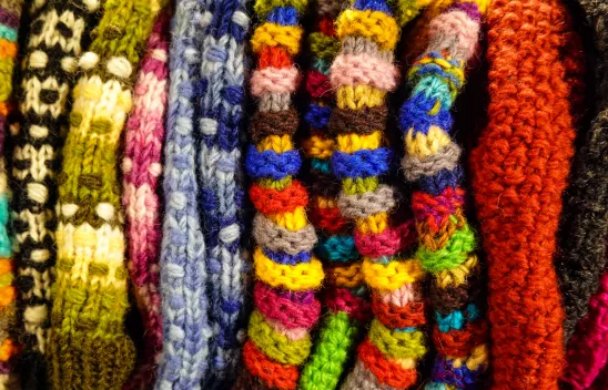 Strickzeug aus bunter Wolle als Sinnbild für die Verwobenheit sozialer Kategorien aus intersektionaler Perspektive.