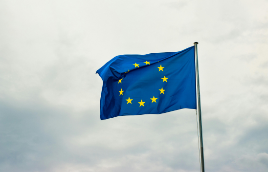 Die Flagge Europas, wehend an einer Fahnenstange. 